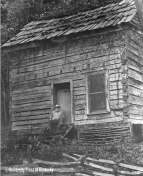 [James Still at the Amburgey cabin, 1983.] This log cabin on Dead Mare Branch near Hindman, Kentucky, was once the home of dulcimer maker Jethro Amburgey. In his will he bequeathed a lifetime habitation of the cabin to his lifelong friend, author James Still.
